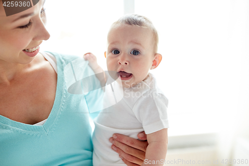 Image of happy young mother with little baby at home