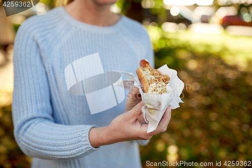 Image of close up of woman with hot dog