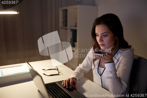 Image of woman using voice command recorder on smartphone