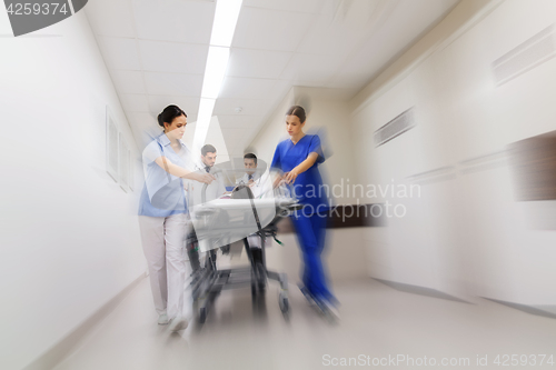 Image of medics and patient on hospital gurney at emergency