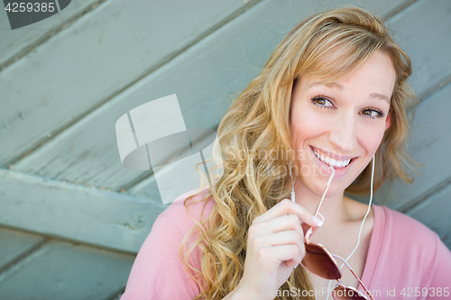 Image of Outdoor Portrait of Young Adult Brown Eyed Woman With Sunglasses