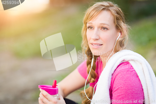 Image of Young Fit Adult Woman Outdoors With Towel and Water Bottle in Wo