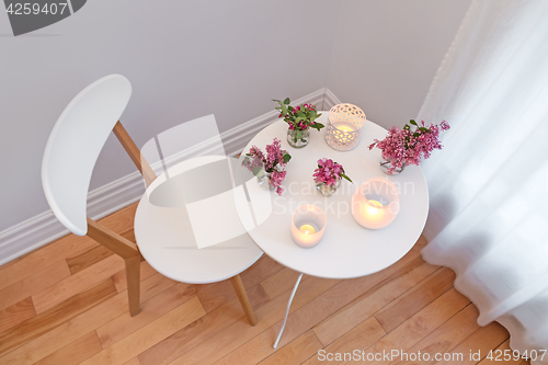 Image of Cozy interior with candle lights and spring flowers