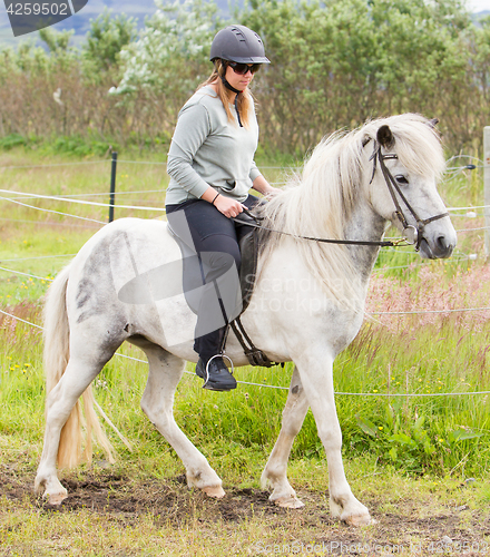 Image of Woman riding a horse