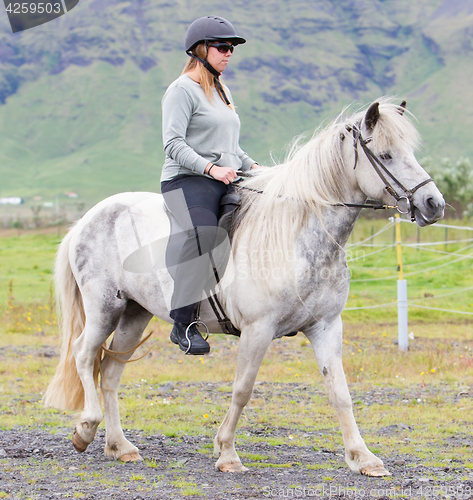 Image of Woman riding a horse