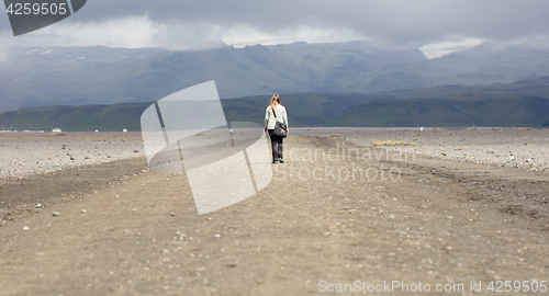 Image of Woman hiker walking in mountain landscape