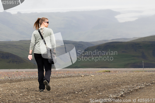 Image of Woman hiker walking in mountain landscape