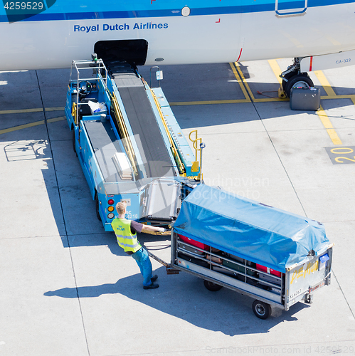 Image of AMSTERDAM, NETHERLANDS - AUGUST 17, 2016: Loading luggage in air