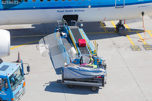 Image of AMSTERDAM, NETHERLANDS - AUGUST 17, 2016: Loading luggage in air