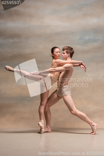 Image of Couple of ballet dancers posing over gray background