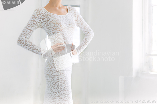 Image of Young and incredibly beautiful ballerina is posing and dancing in a white studio