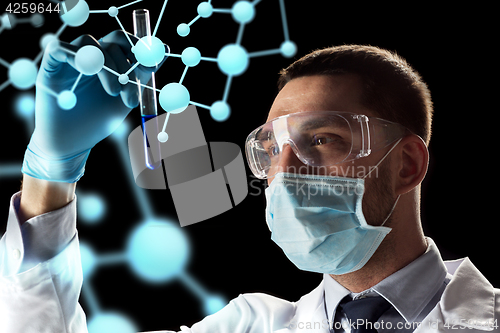 Image of scientist with test tube and molecule projection