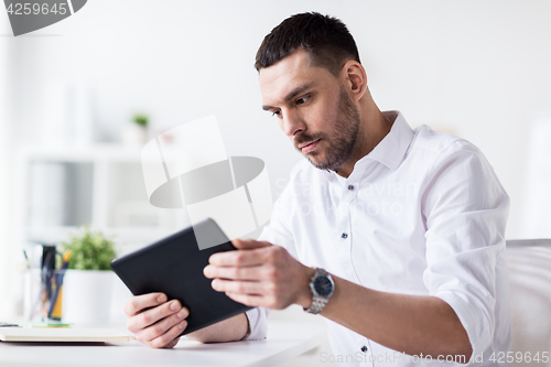 Image of businessman with tablet pc at office