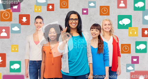 Image of international group of happy women showing ok