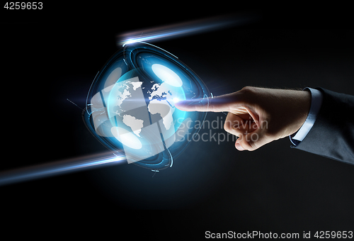 Image of hand pointing finger to virtual earth projection