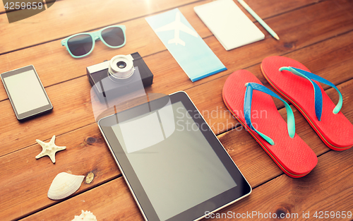 Image of close up of tablet pc and travel stuff