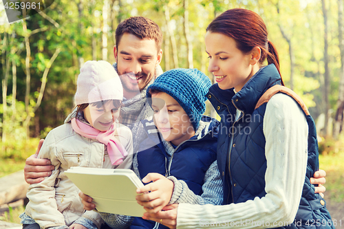 Image of happy family with tablet pc at camp