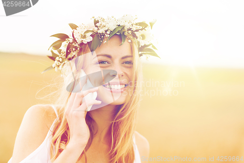 Image of happy young woman calling on smartphone at country