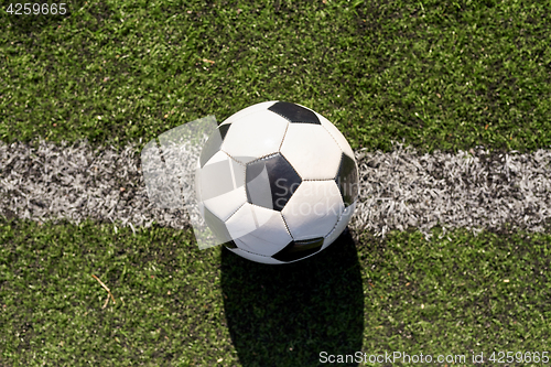 Image of soccer ball on football field marking line