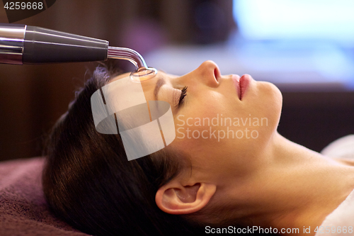 Image of woman having hydradermie facial treatment in spa