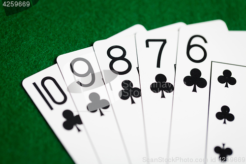 Image of poker hand of playing cards on green casino cloth