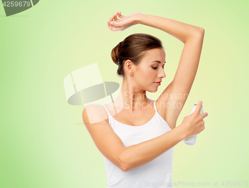 Image of woman with antiperspirant deodorant over white