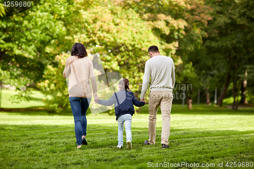 Image of happy family walking in summer park