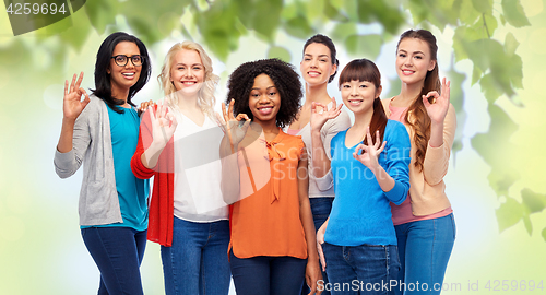 Image of international group of happy women showing ok