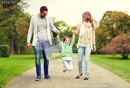 Image of happy family walking in summer park and having fun