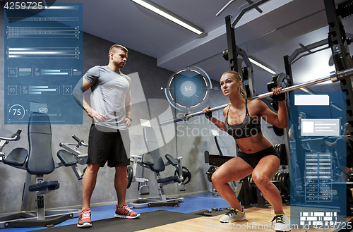 Image of man and woman with bar flexing muscles in gym