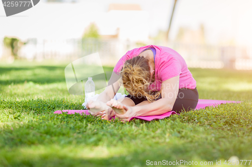 Image of Young Fit Flexible Adult Woman Outdoors on The Grass With Yoga M