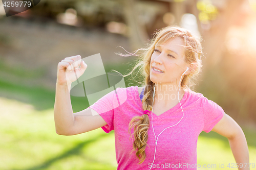 Image of Young Fit Adult Woman Outdoors During Workout Listening To Music