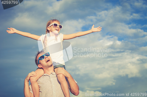 Image of Father and daughter playing in the park  at the day time.