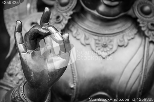 Image of Detail of Buddha statue with Karana mudra hand position