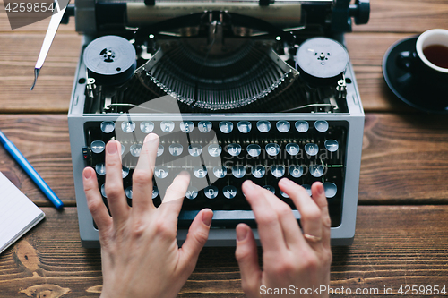 Image of Crop person using typewriter