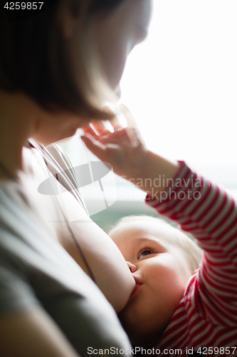 Image of Woman breastfeeding her child