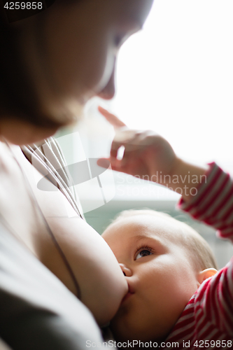 Image of Woman breastfeeding her child