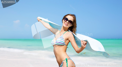 Image of woman in bikini and sunglasses with pareo on beach