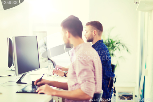 Image of creative man or student with computer at office