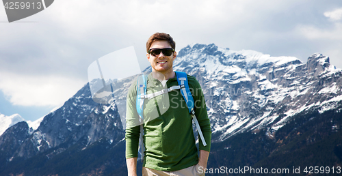 Image of happy man with backpack traveling in highlands