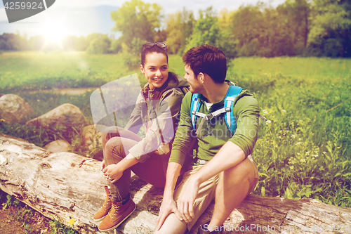 Image of smiling couple with backpacks in nature