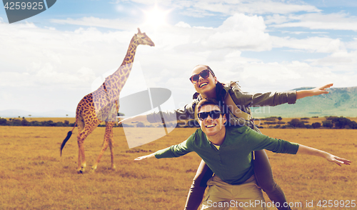 Image of happy couple with backpacks having fun in africa