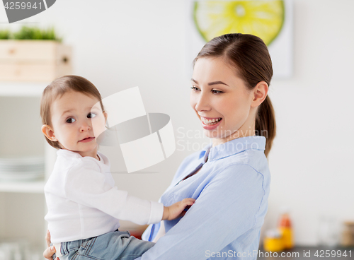 Image of happy mother and little baby girl at home kitchen