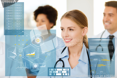 Image of happy doctor over group of medics at hospital