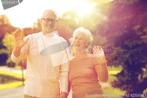 Image of senior couple hugging in city park