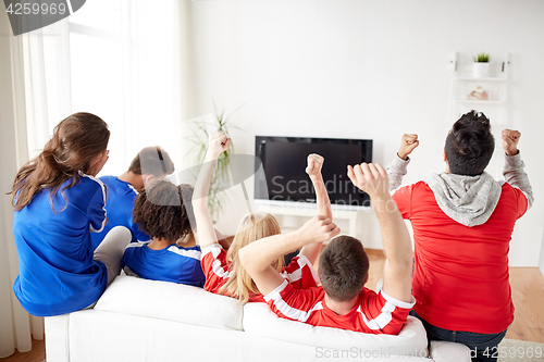 Image of friends or football fans watching tv at home