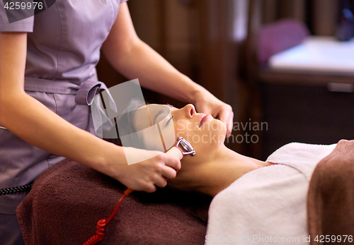 Image of woman having hydradermie facial treatment in spa