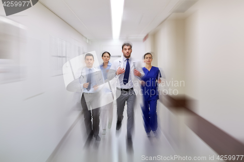 Image of group of medics walking along hospital