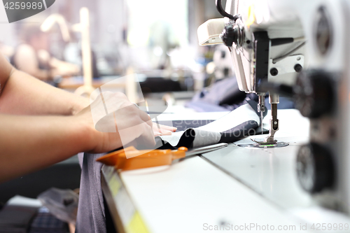 Image of Sewing. Seamstress on the machine.