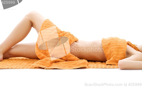 Image of torso of relaxed lady with orange towels